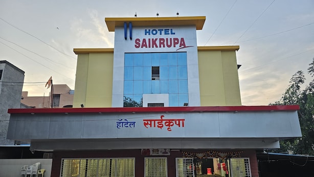 A hotel named "SAIKRUPA" with a modern facade, large windows, and a visible entrance. - Hotel Saikrupa (Rahata)