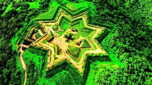 An aerial view of a star-shaped fort with multiple bastions, surrounded by dense forest. - Tusker Valley Resort (Sakleshpur)