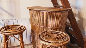 A rustic interior with a large wooden barrel, two wicker stools, and a wooden ladder leaning against the wall. - Country house with terrace and fireplace, accessible for PRM, near water activities (Saint-Aignan-sur-Roë)