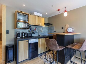 Enjoy cooking and dining in this well-equipped kitchen with a microwave, coffee maker, toaster, and dishwasher.