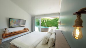 Une chambre moderne avec un grand lit, un téléviseur fixé au mur et une vue sur une piscine.