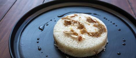 A dessert on a dark plate with a wooden table background.