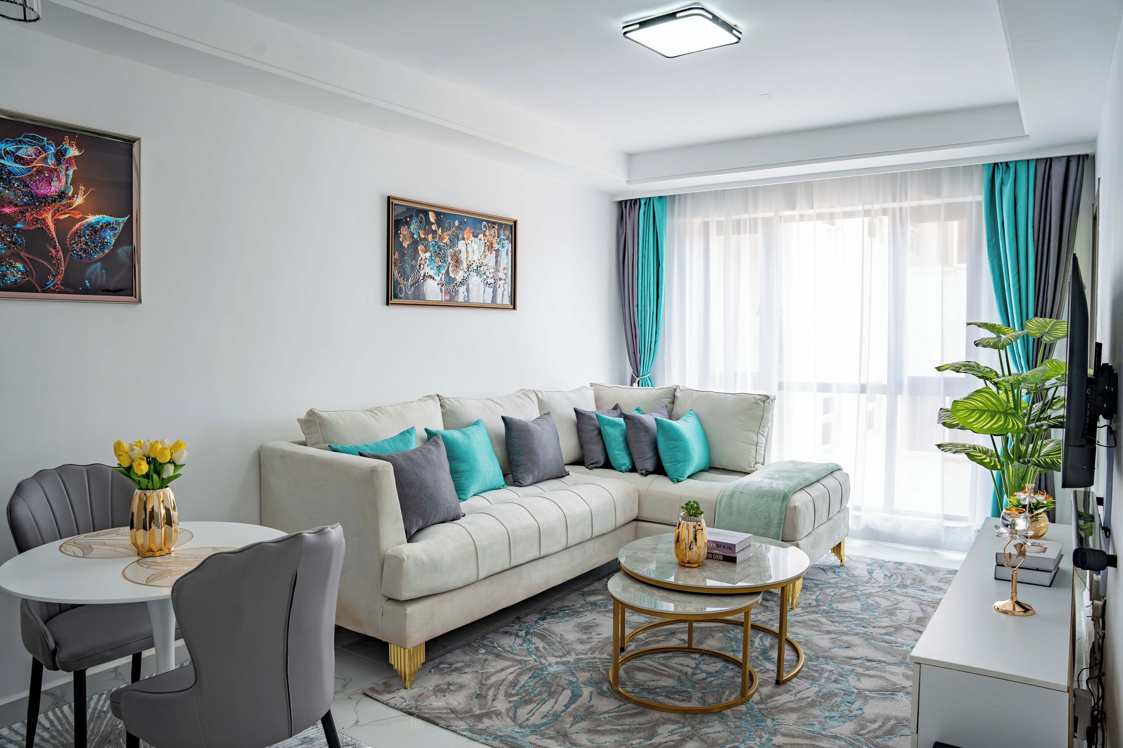 A modern living room with a sofa, a coffee table, and a dining area.