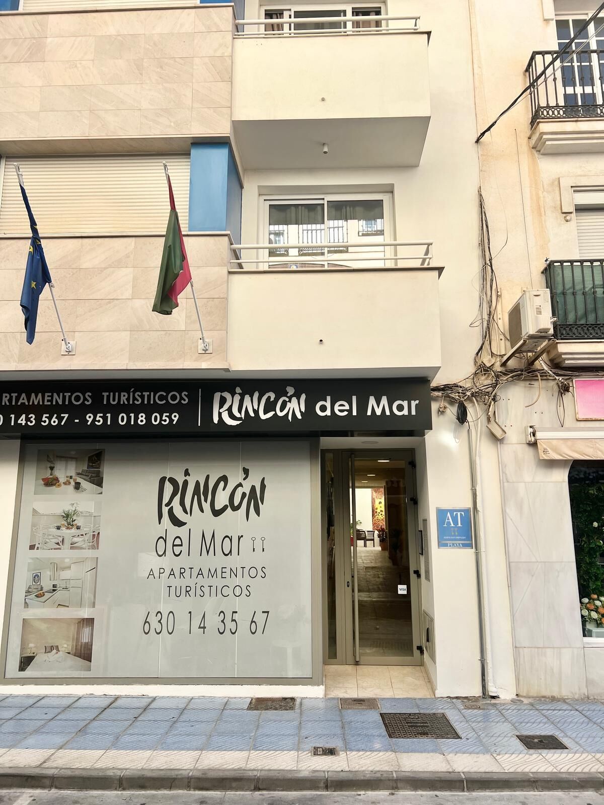A building with a sign for 'Rincon del Mar' indicating it is a tourist accommodation.