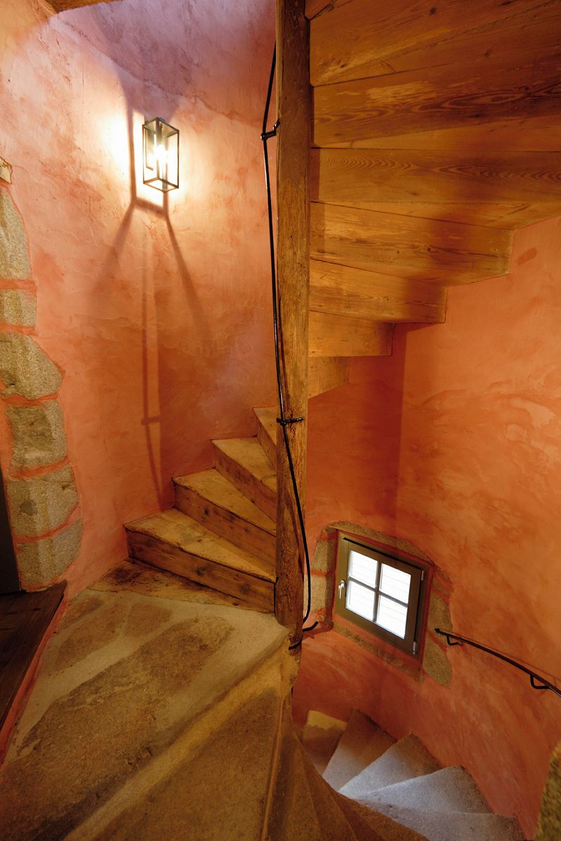 A wooden staircase with a small window at the bottom.