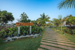 A pathway leading to a sign labeled "Kapila Riverfront." - Kapila Riverfront (Nanjangud)