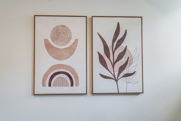 Two framed artworks on a wall.
