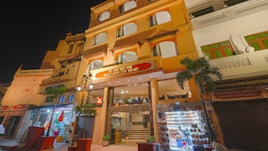 A multi-story building with a sign reading "One Earth City Heart." - One Earth City Heart Amritsar (Amritsar)