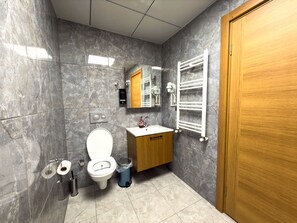 Shower, hair dryer, slippers, towels