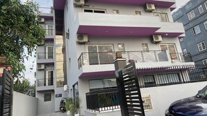 A multi-story building with balconies and air conditioning units. - Solhouse Serviced Apartments Gurgaon (Gurugram)