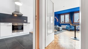 A modern kitchen with a Bosch oven, a built-in stove, and a stainless steel range hood. - 4ty3-Apartments Naschmarkt City Apt (Vienna)