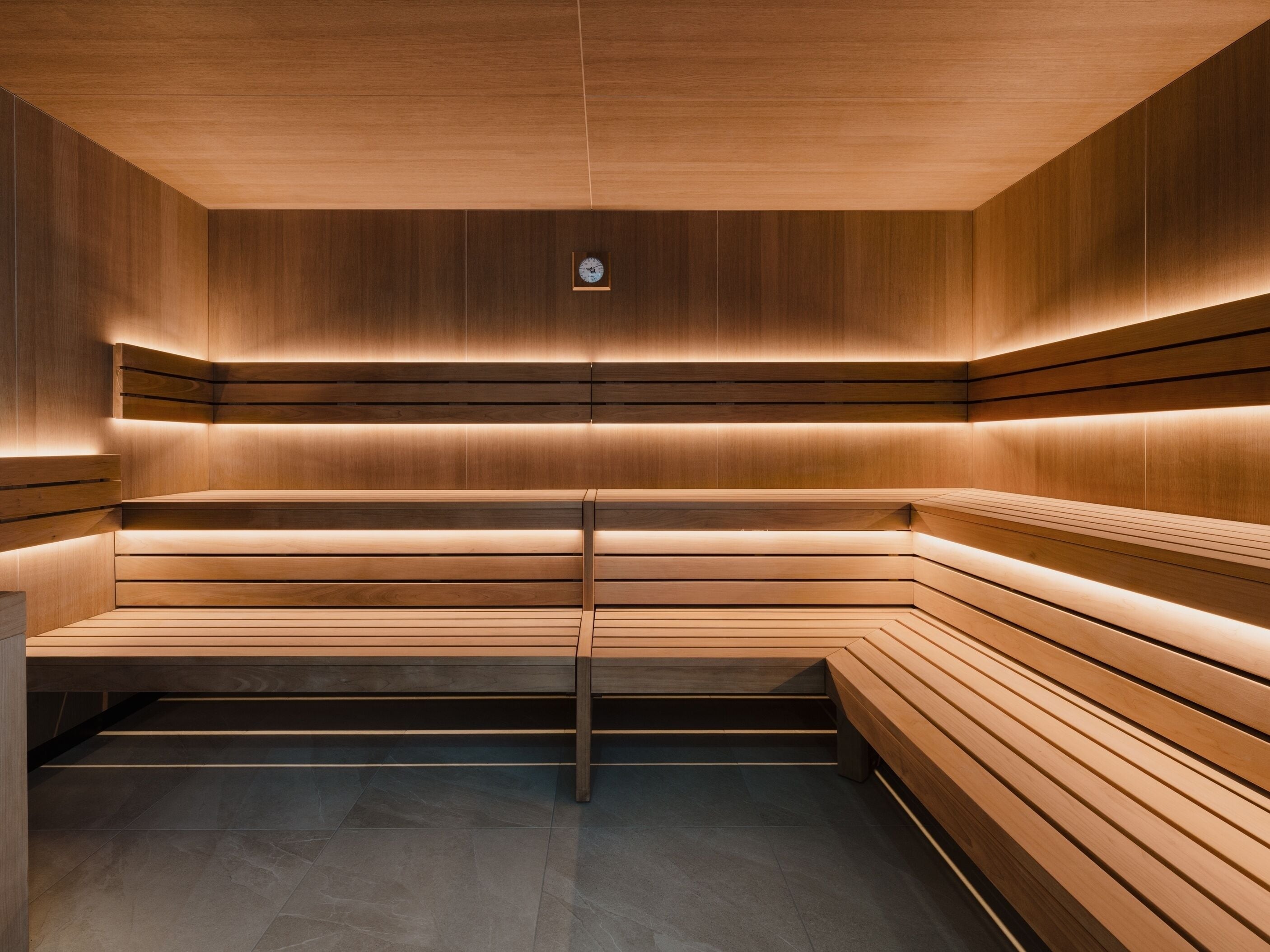 A modern, minimalist interior with wooden paneling and built-in benches.