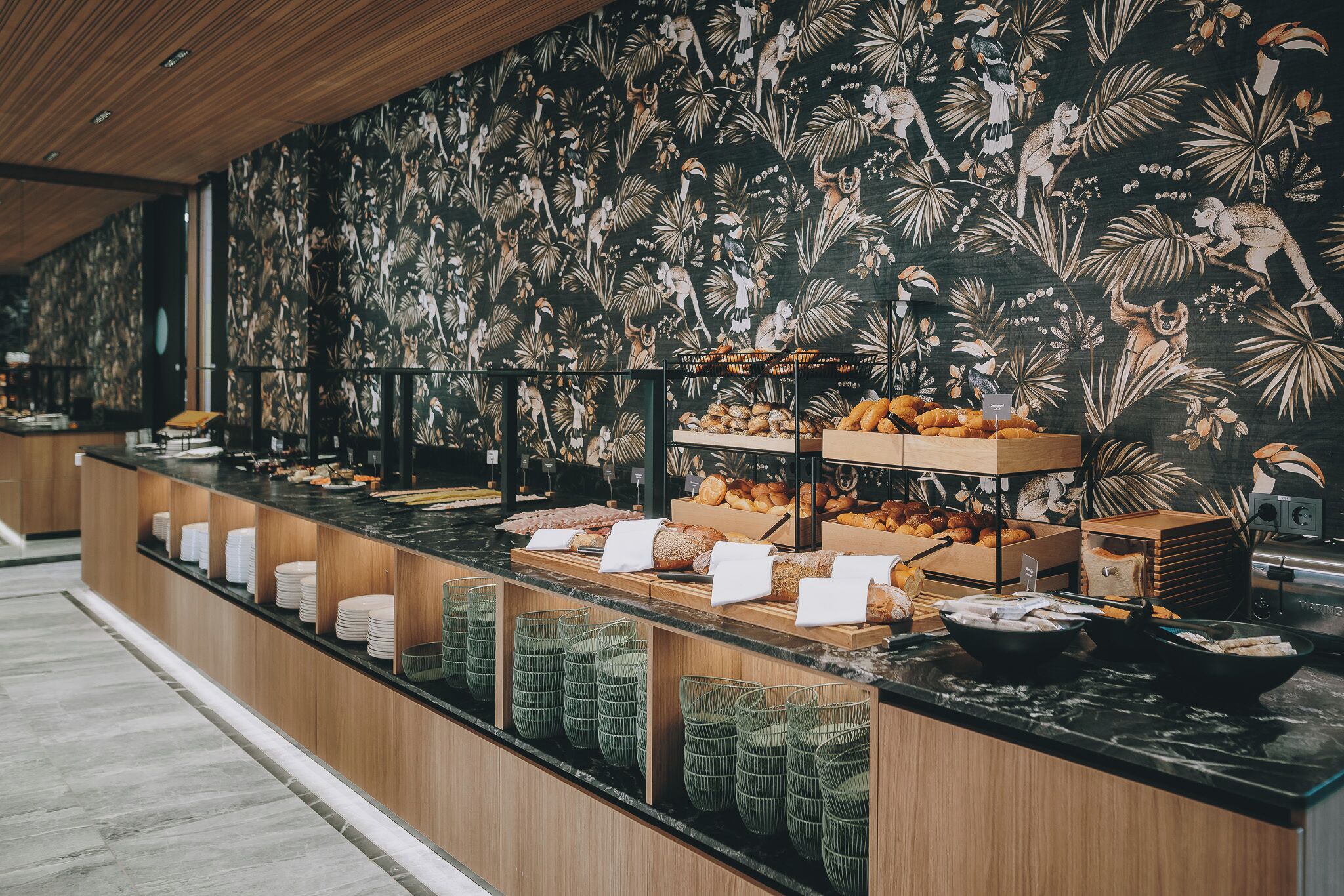 A buffet counter with various food items and baskets.