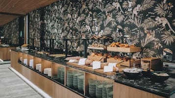 A buffet counter with various food items and baskets.