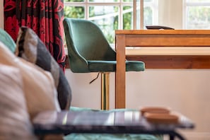 Relax in a serene room with a comfortable bed and a view of lush greenery.