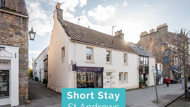 A traditional building with a sign for St Andrews Property Centre.