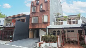 A modern building with a unique architectural design, featuring a combination of metal and concrete materials. - Hotel O Pondok Indah Near Gandaria City Formerly Odori Residence (Jakarta)