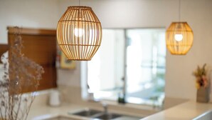 A modern kitchen with pendant lights, a sink, and a window. - Elevated Resort-style Terrace near Botanic Gardens (Cairns North)