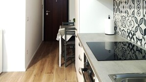 A modern kitchen with a built-in stove, a sink, and a patterned backsplash. - Mayflowers Apartment  - Biancospini (Milan)