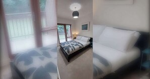 A bedroom with a bed, a bedside table, a lamp, and a window with blinds.