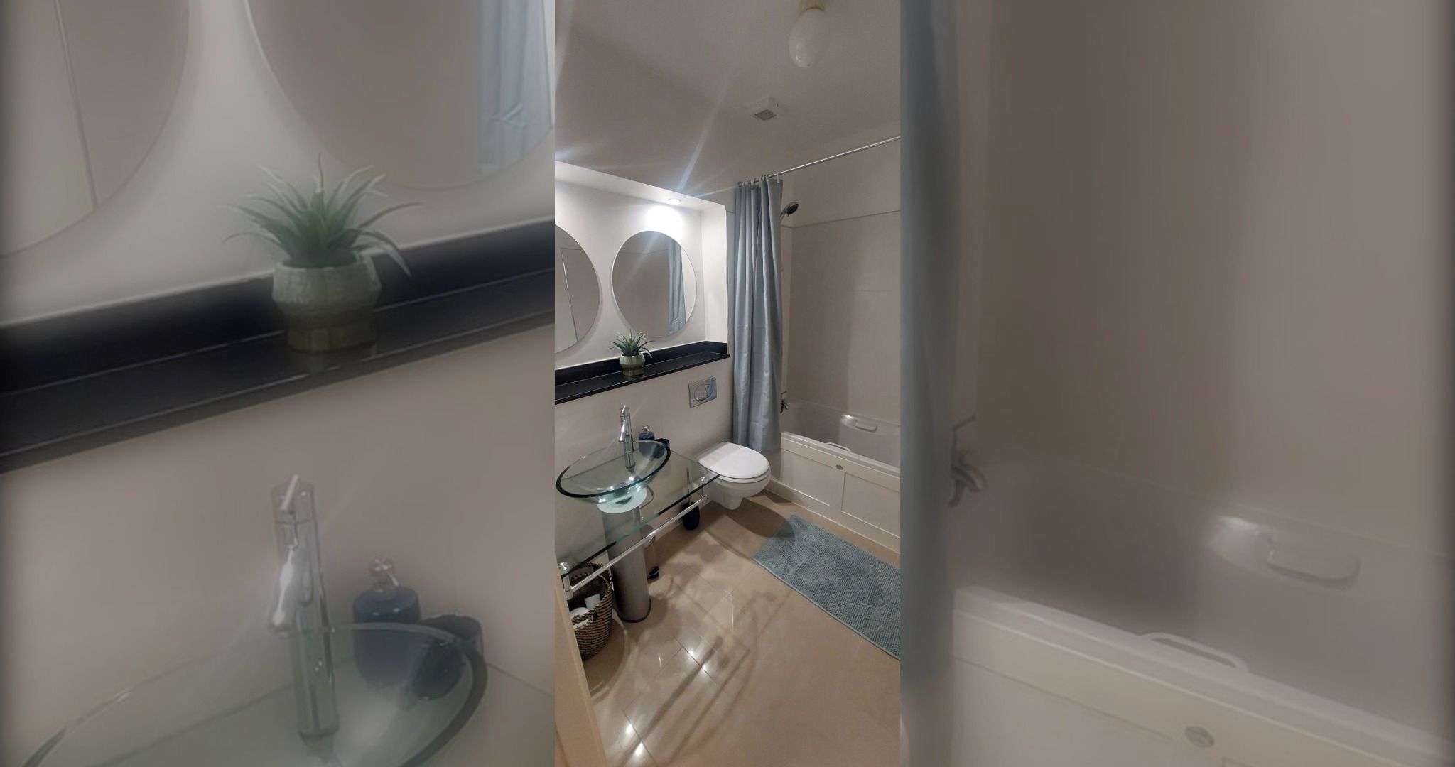 A modern bathroom with a glass sink, a toilet, and a shower area.