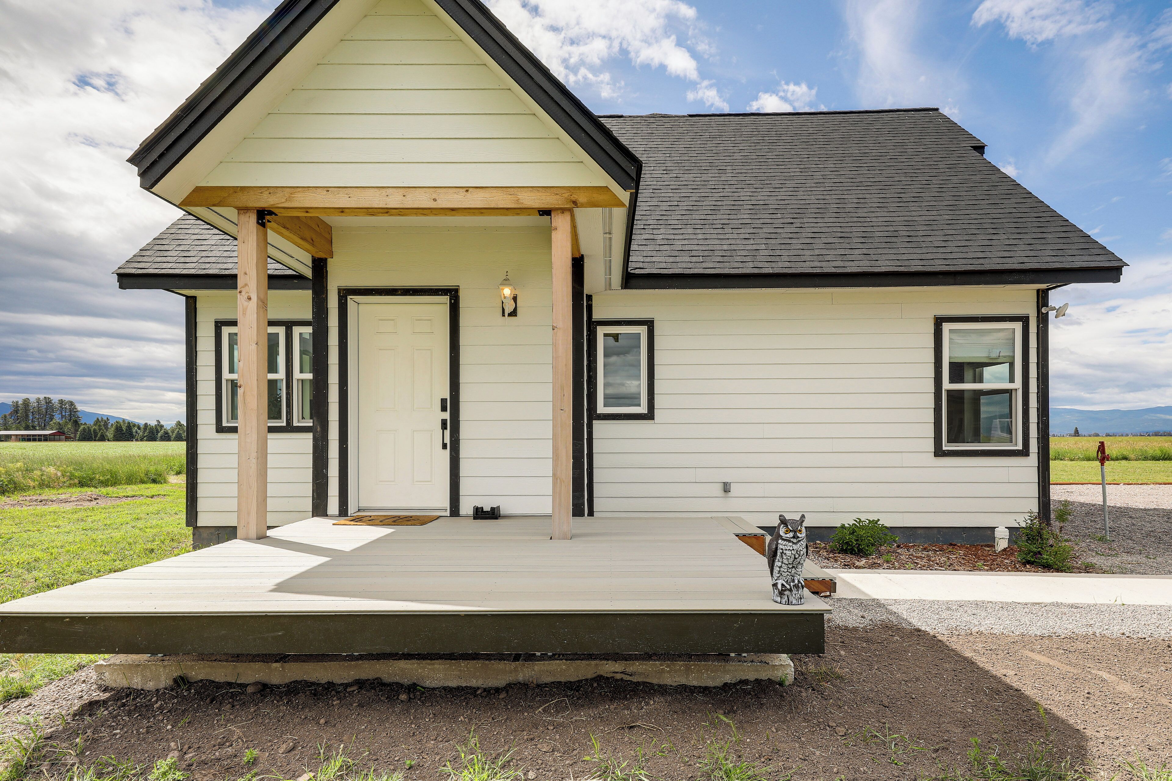 A single-story house with a front porch, a door, and a window.