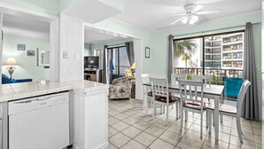 A kitchen with a dishwasher, dining table with chairs, and a ceiling fan. - A110 at the Myrtle Beach Resort (Myrtle Beach)