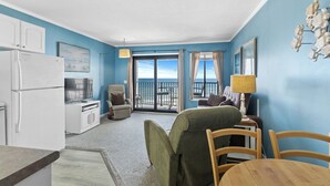 A compact room with a kitchenette, a dining area, and a balcony with a view. - A504 at The Myrtle Beach Resort (Myrtle Beach)