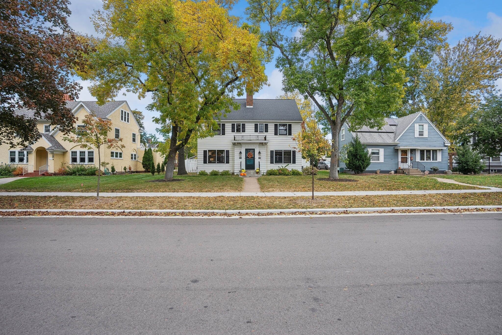 A two-story house with a front porch, a garage, and a driveway.