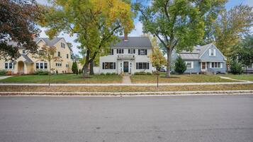 A two-story house with a front porch, a garage, and a driveway.