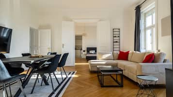 Deluxe Apartment, City View | Living area | Flat-screen TV