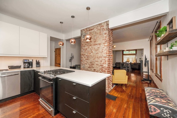 The sleek, open kitchen offers ample space & every home comfort