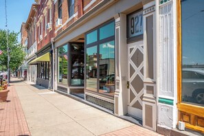 A row of brick buildings with large windows and a sidewalk. - Monmouth Loft 4 | Walk to Shops (Newport)