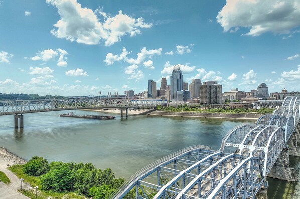 Une vue sur les toits d’une ville, avec des bâtiments modernes, une rivière et un pont.