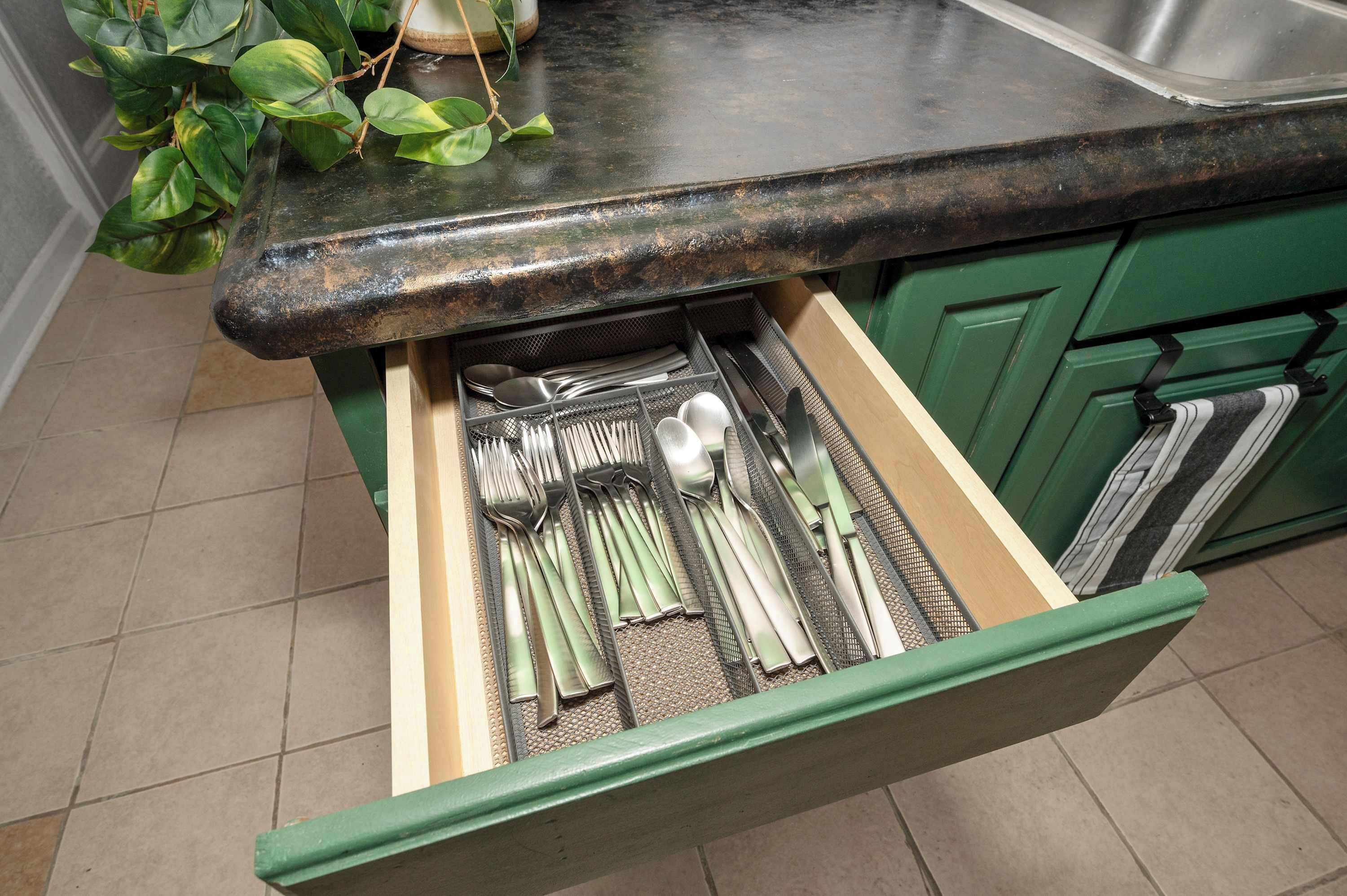 A kitchen drawer with utensils.