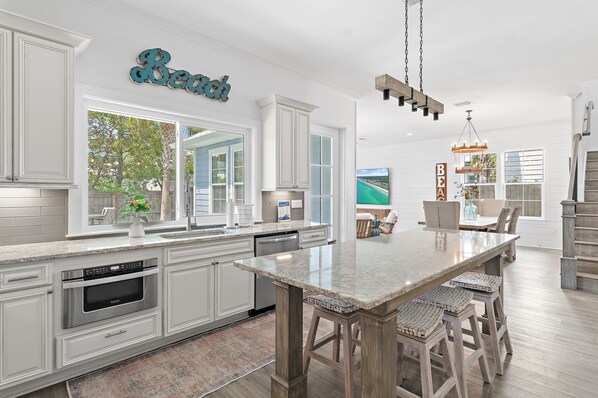 Coffee/tea maker, toaster, dining tables, kitchen islands