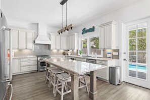 Coffee/tea maker, toaster, dining tables, kitchen islands