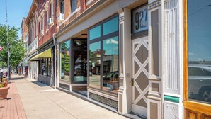 A row of brick buildings with large windows and a sidewalk. - Monmouth Loft 3 | Heart of Newport (Newport)