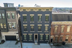 A multi-story building with a central entrance, large windows, and a flat roof. - OTR 1BR | Private Balcony | Near Downtown (Cincinnati)