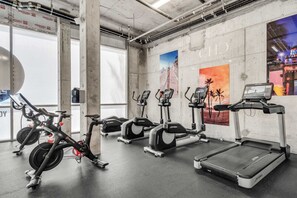 A gym with stationary bikes, elliptical machines, and treadmills.