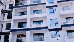 A high-rise building with multiple balconies and large windows. - spacious 3 bedroom in kilimani gym&pool (Nairobi)