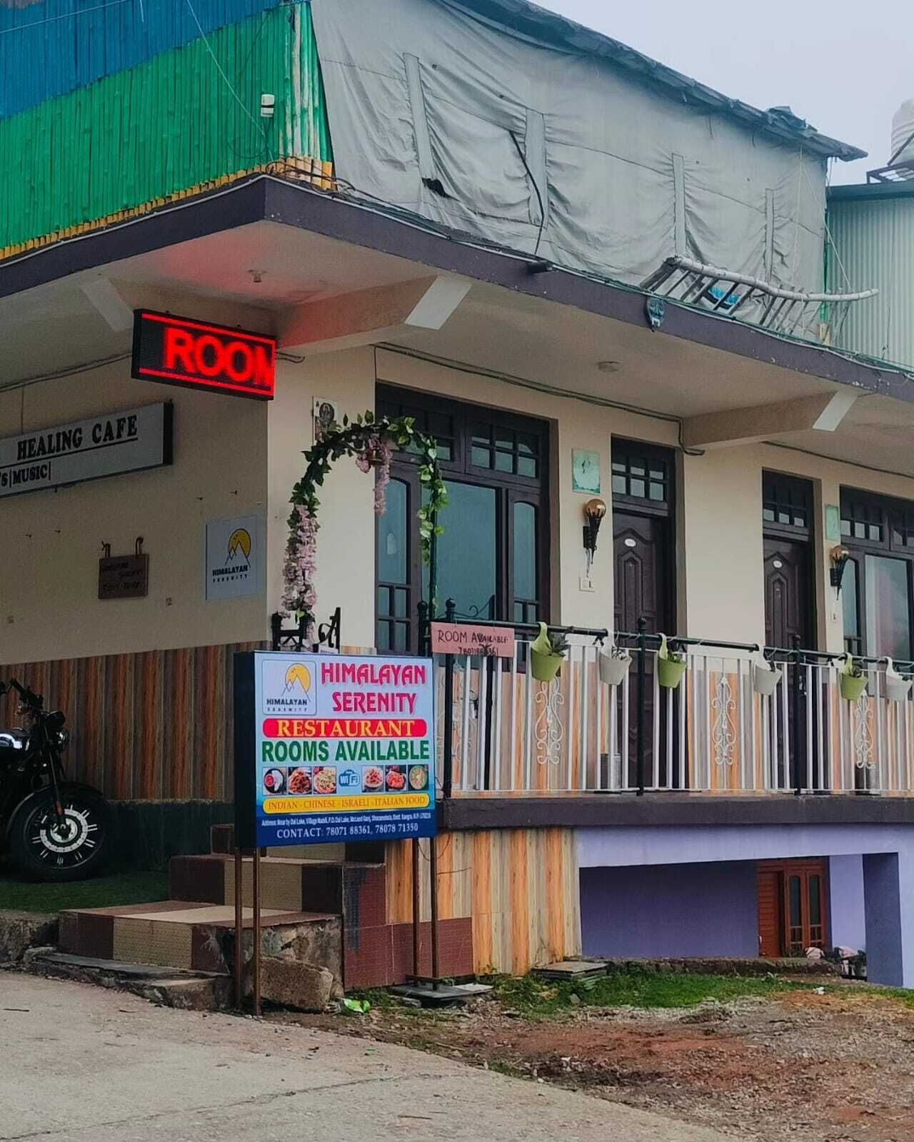 A building with a sign for a restaurant named 'Himalayan Serenity' and a sign indicating 'Room Available'.