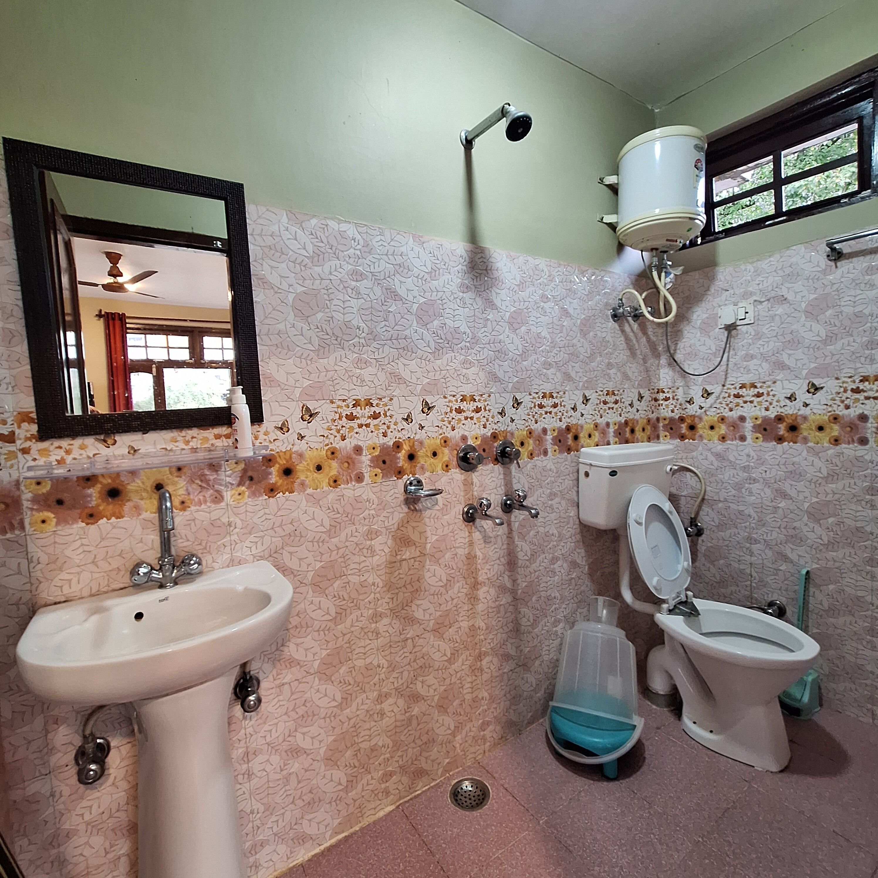 A bathroom with a sink, toilet, and shower.