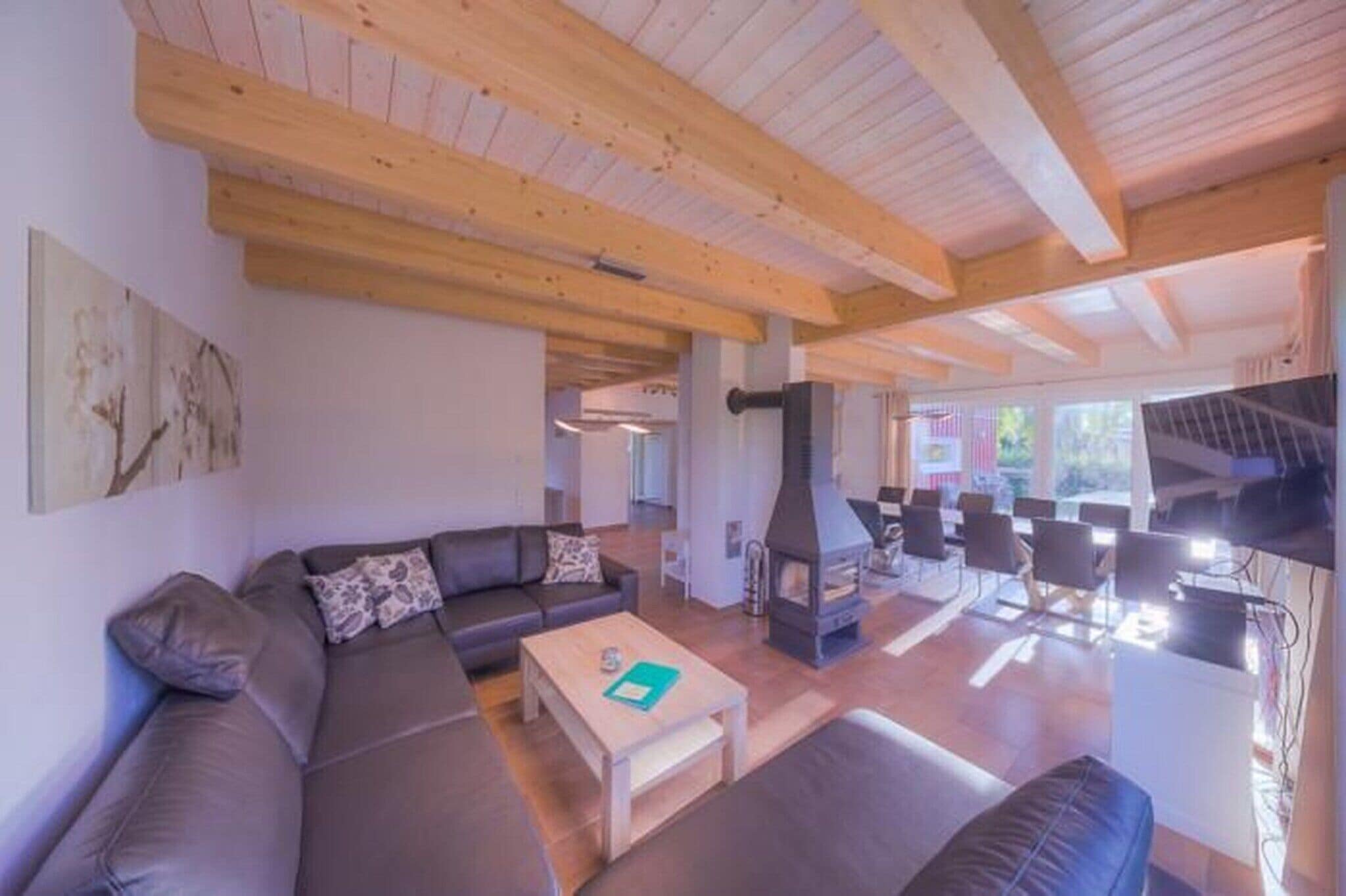 A modern living room with a sofa, coffee table, and fireplace.