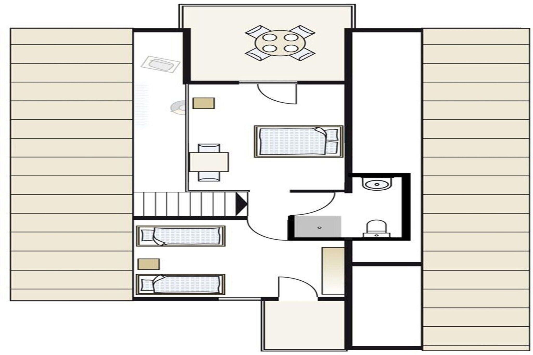 Et plantegningsbillede af et hotelværelse med seng, skrivebord, stol, badeværelse og en lille siddeplads.