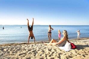 Guests can enjoy a serene beach experience with calm waters and plenty of space to relax and play.