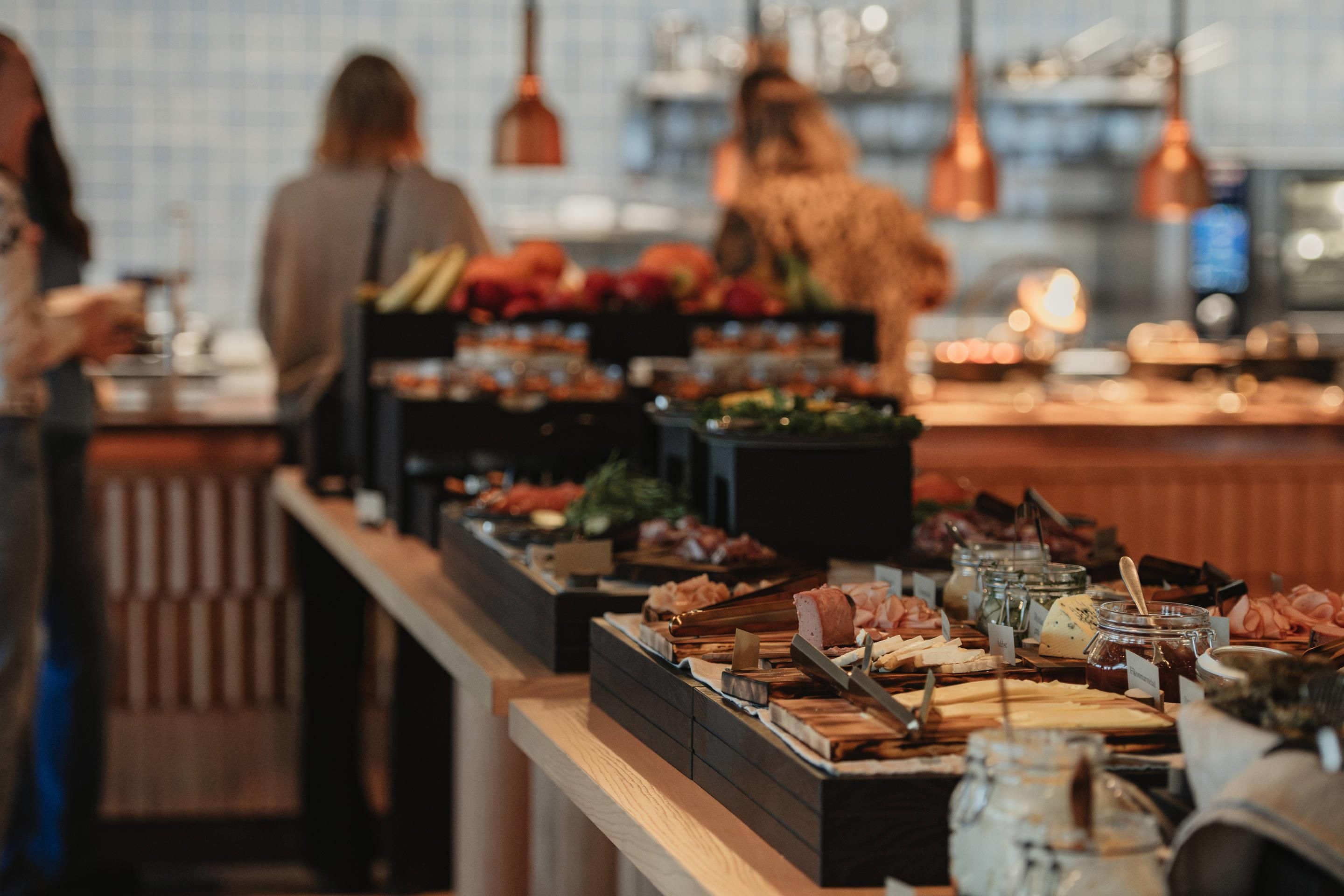 A buffet setup with various food items and condiments.