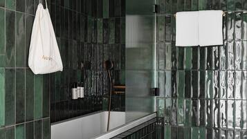 Un baño moderno con una bañera independiente, un inodoro y una zona de ducha.