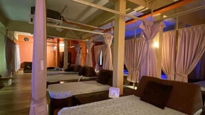 A hotel room with a bed, a nightstand, and a window with curtains. - Anggun Lodge Private Room with Sharing Bathroom (Semporna)