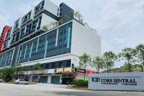 A modern building with a sign for "KIP. Core Sentral" and "Core Soho Suites." - CoreSoho Suite by BKAstaycation KotaWarisan Sepang KLIA Airport, Free Wifi (Sepang)
